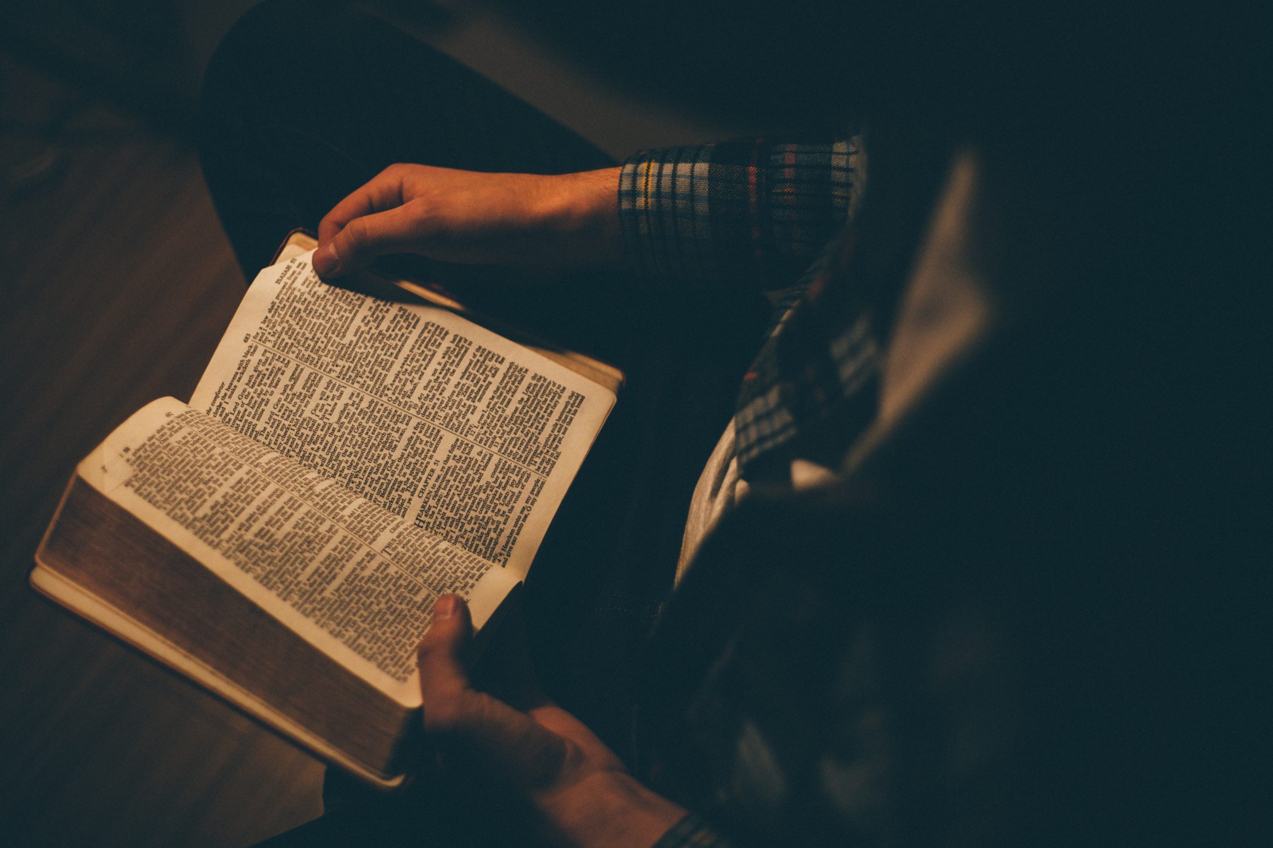 priscilla-du-preez-x_jAYPjskYI-unsplash A picture of someone holding a Bible opened.