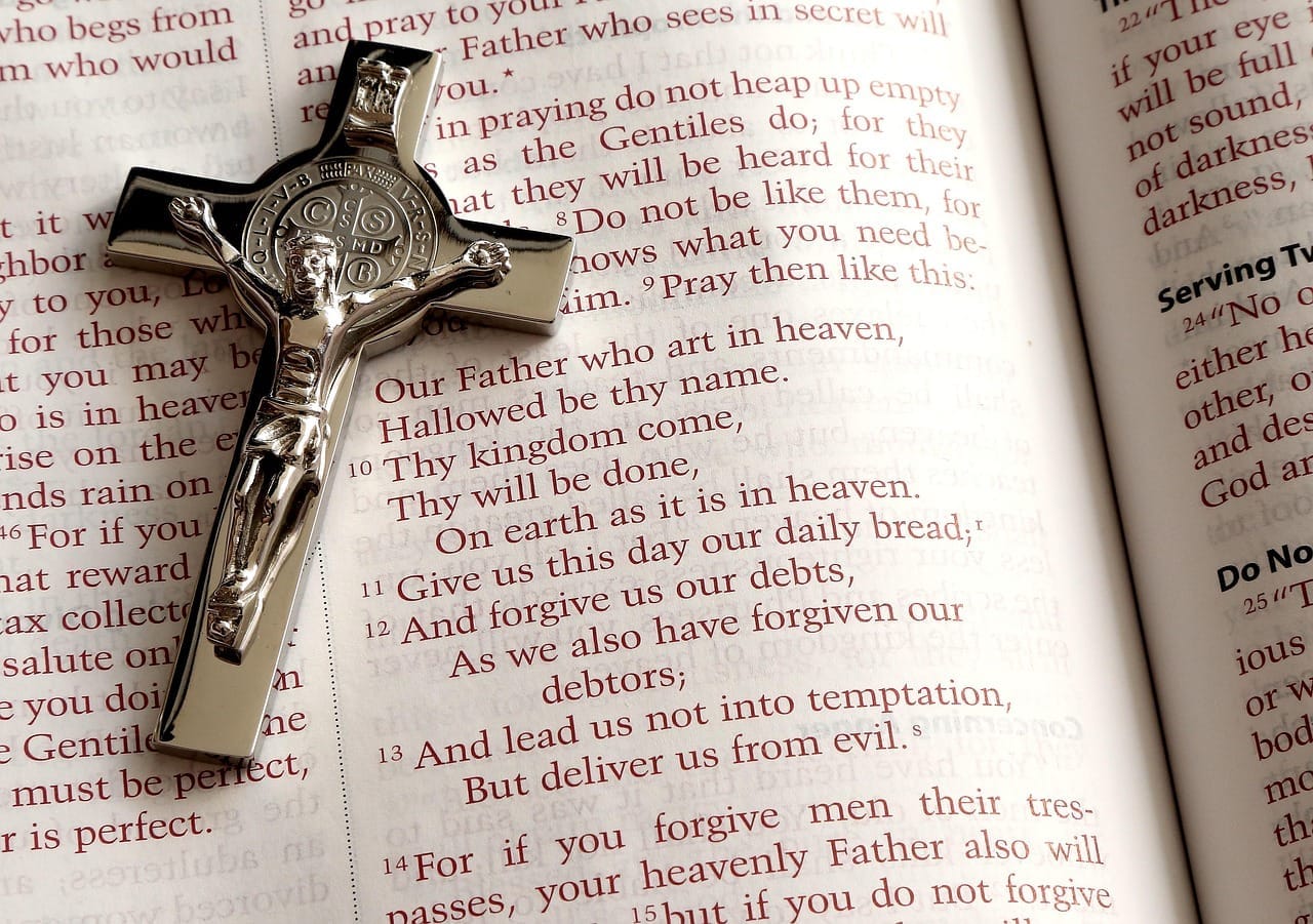 A Bible open with a cross.