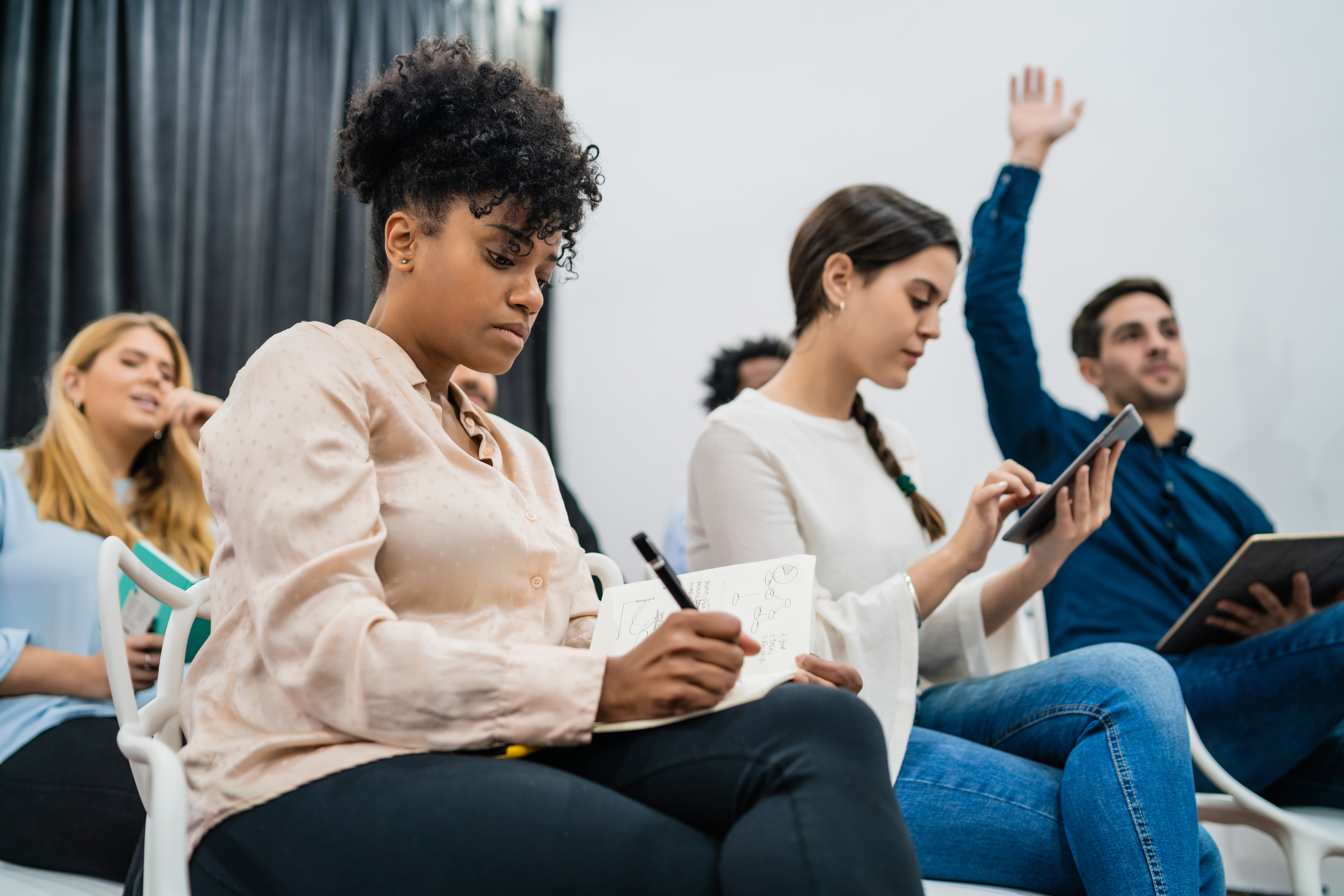 Group of young people sitting on conference together. Image by mego-studio on Freepik