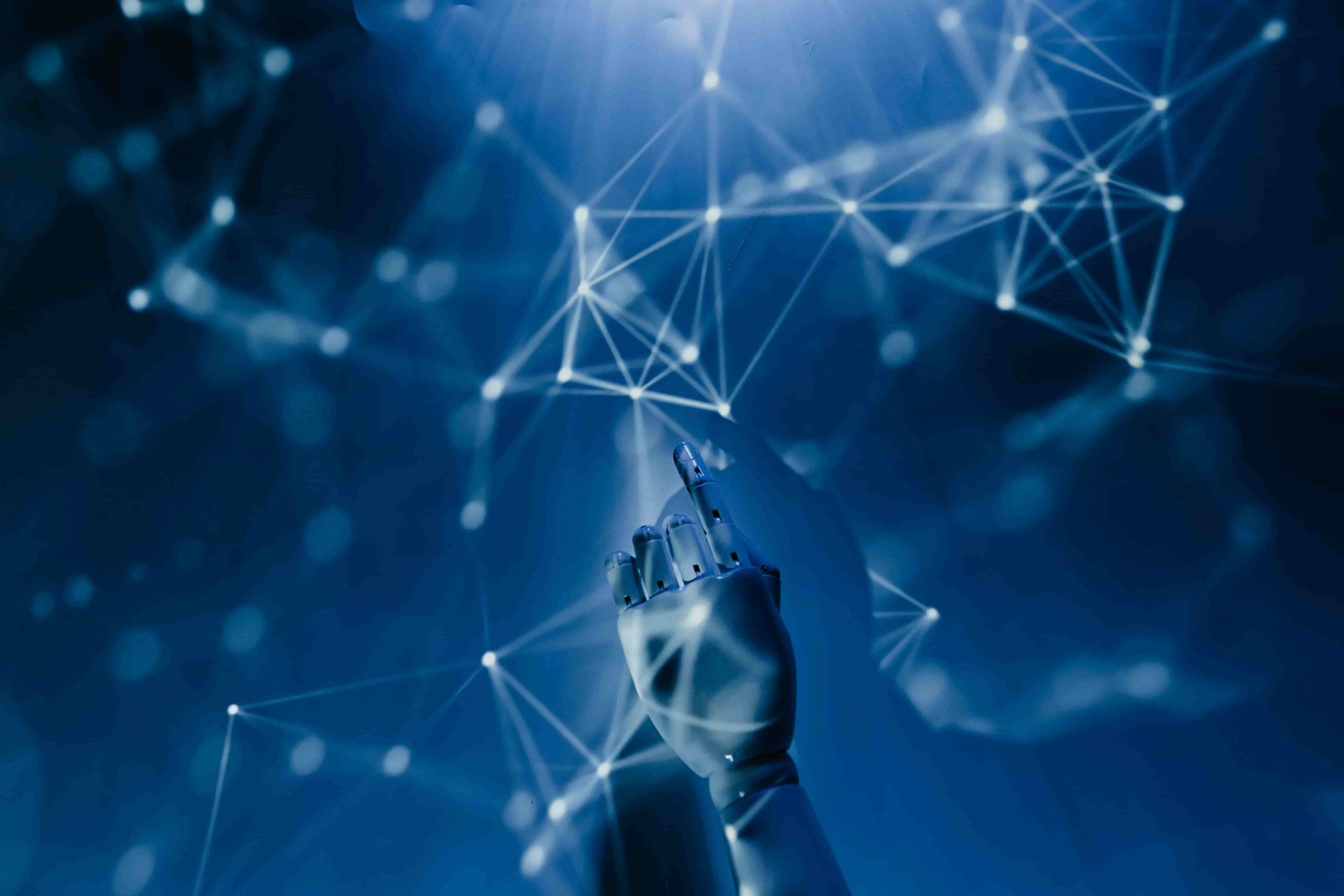 A robotic hand reaching out for lines representing knowledge (similar to star constellations) in a blue and black background
