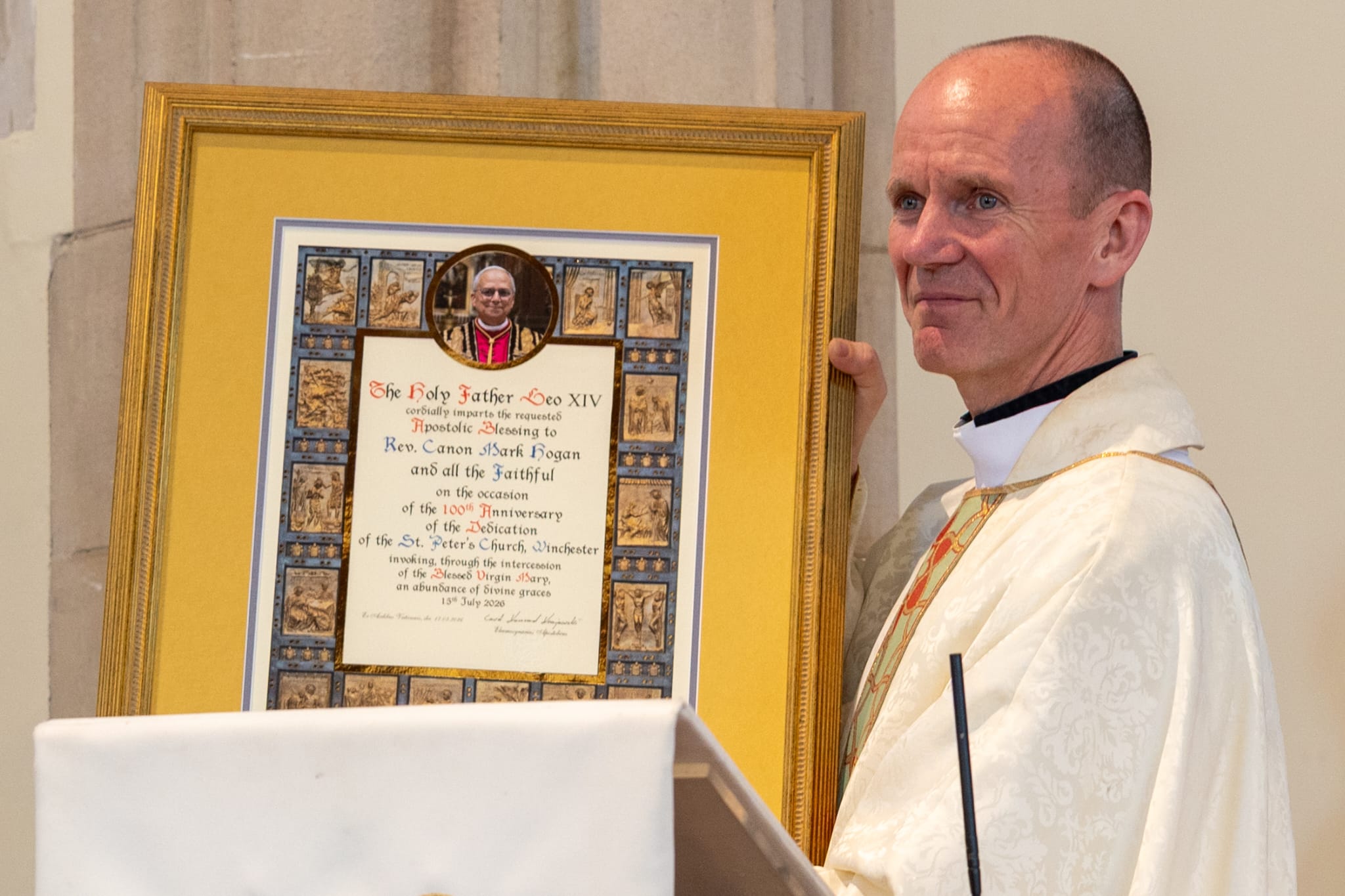 Fr Hogan with Pope Leo XIV on 100th anniversary Fr Hogan holding a memo by Pope Leo XIV on the 100th anniversary of St Peter's in Winchester