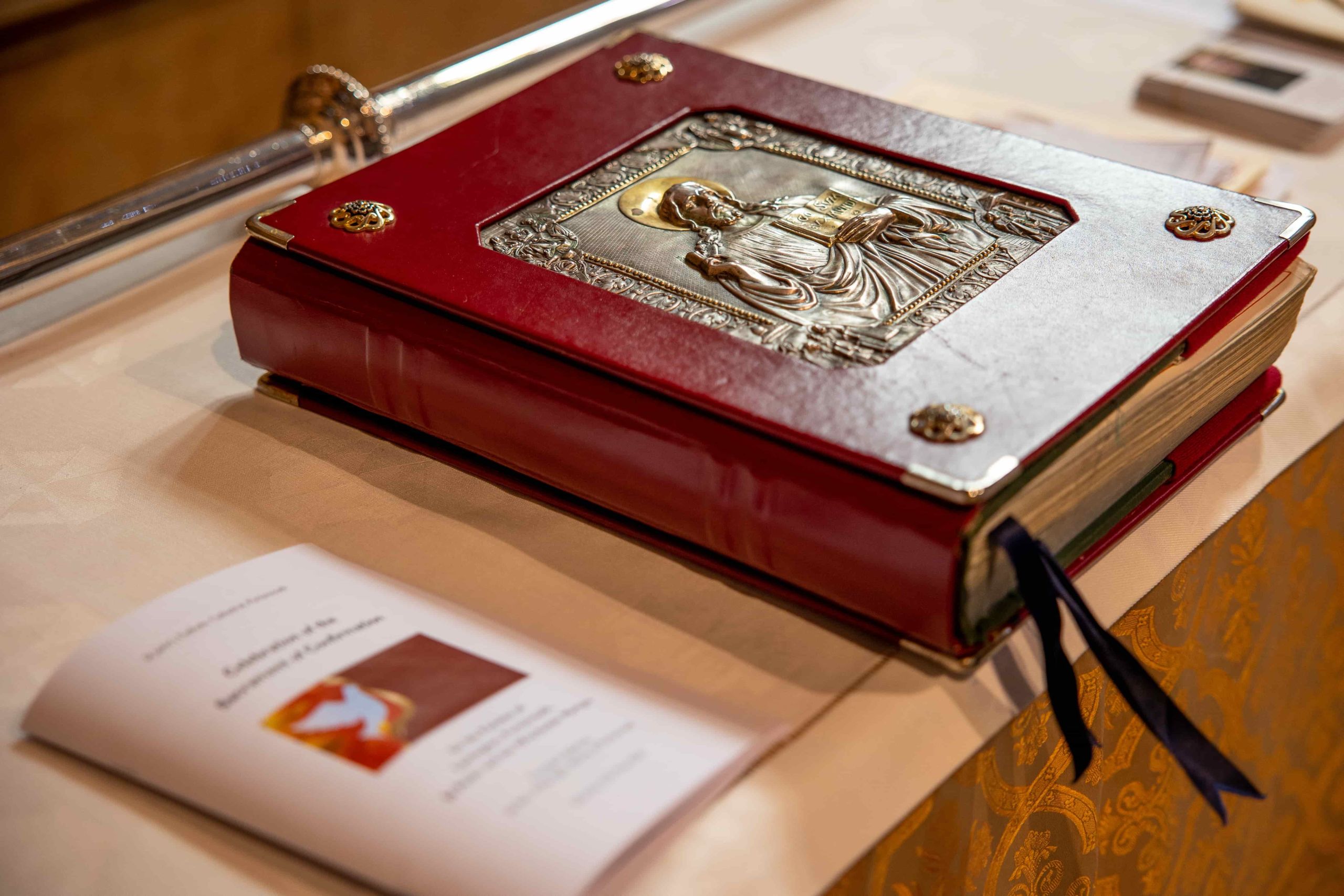 Book of Gospels The Book of Gospels closed. It has a dark red cover with an ornament in golden colours.